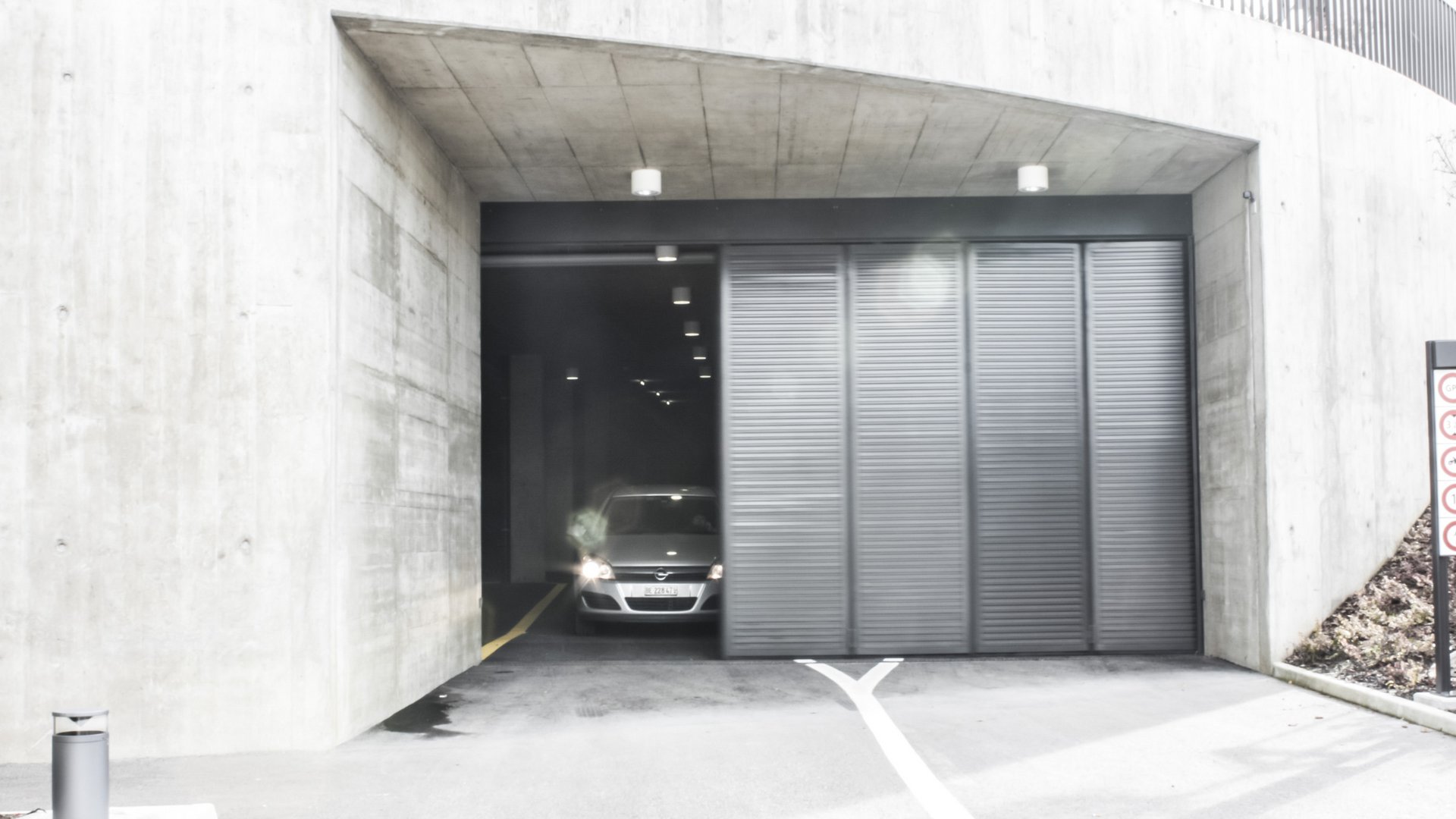 Parkplatzeinfahrt zum CFK-Modelleisenbahnmuseum in Granges-Paccot mit automatischen Torantrieben